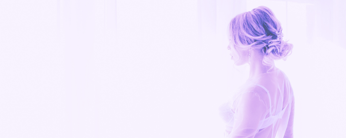 purple filtered woman in lingerie looking out of window